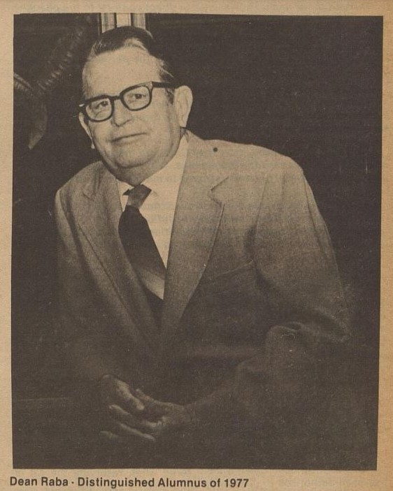 Dean Ernest Raba in suit and tie and glasses, 1977