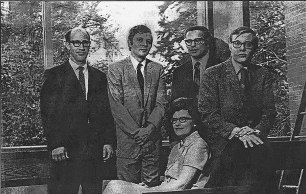 Barbara Bader Aldave sitting in front of other University Oregon Law School staff, 1970s