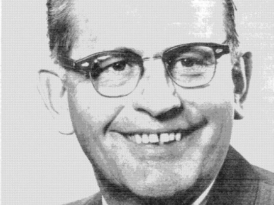 Dean Ernest Raba in suit and tie and glasses